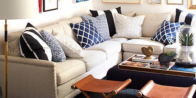 beige couch with blue pillows