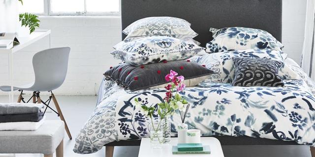 large bed with white and blue duvet